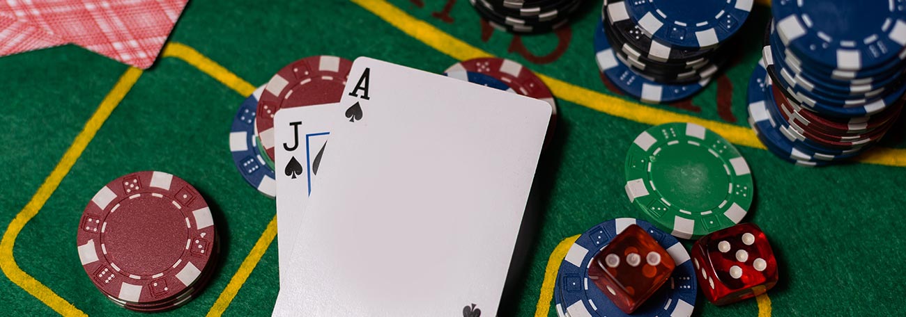 overhead view of blackjack table with chips and a blackjack in spades with an ace and a jack