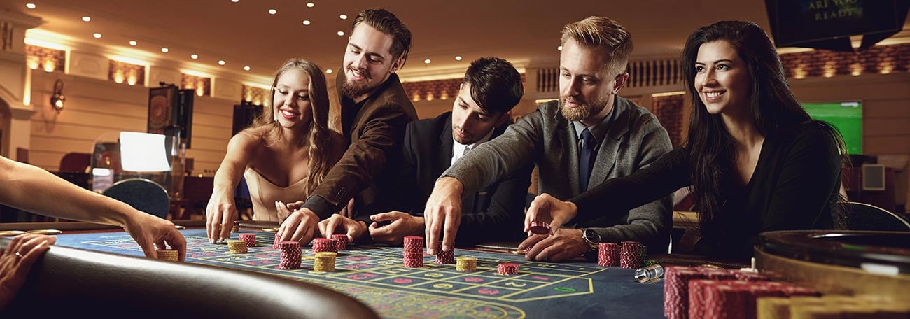 a small group of friends making risky bets at roulette. These players are not outsmarting the casino.