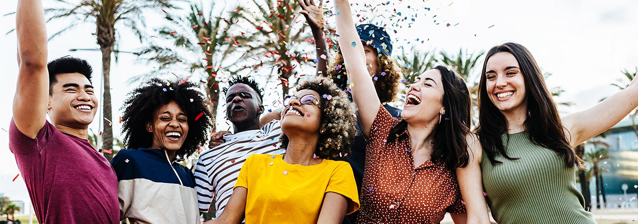 a group of seven very attractive young people having fun outdoors while on vacation